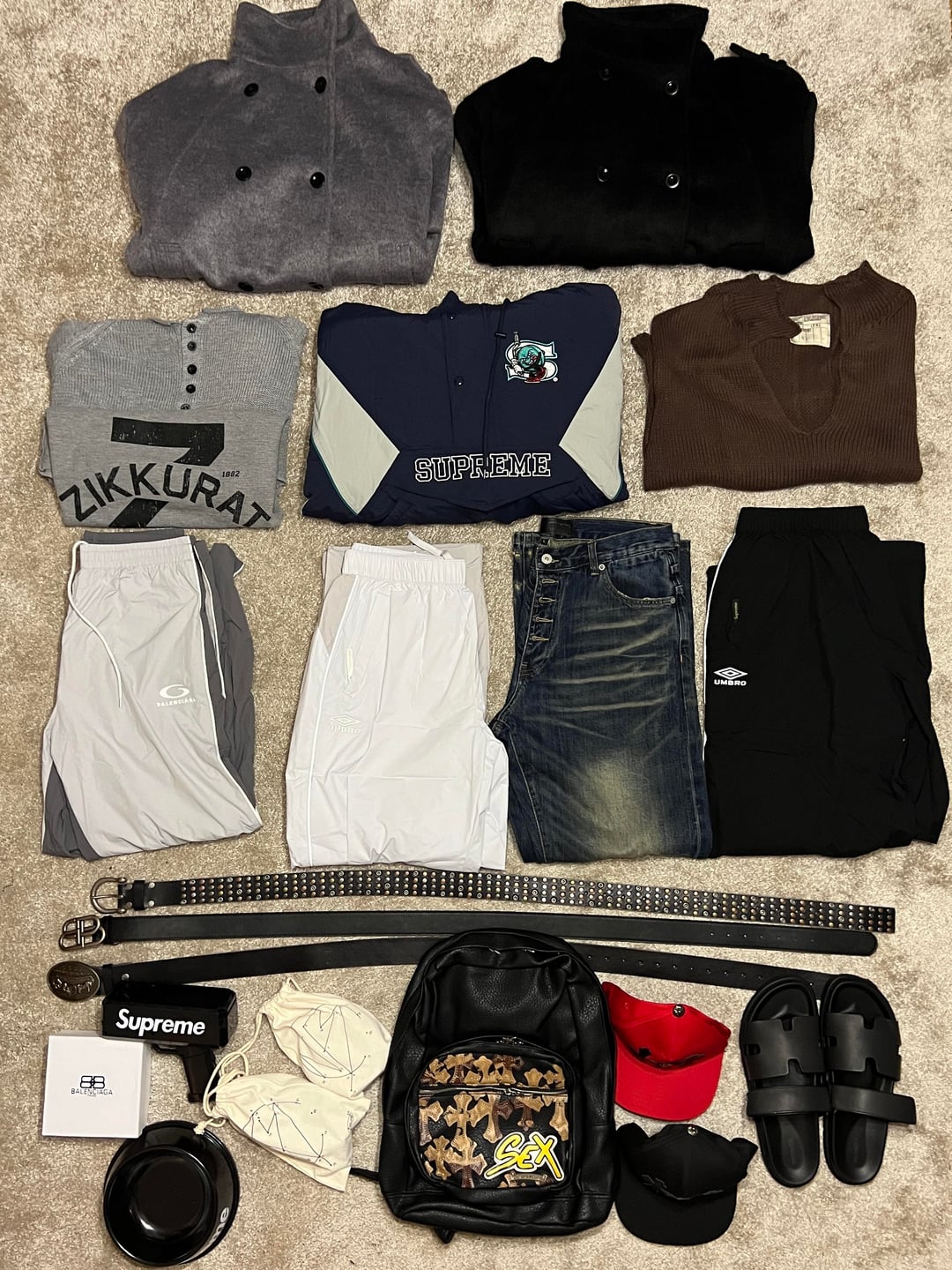 Clothing, belts and accessories laid out together