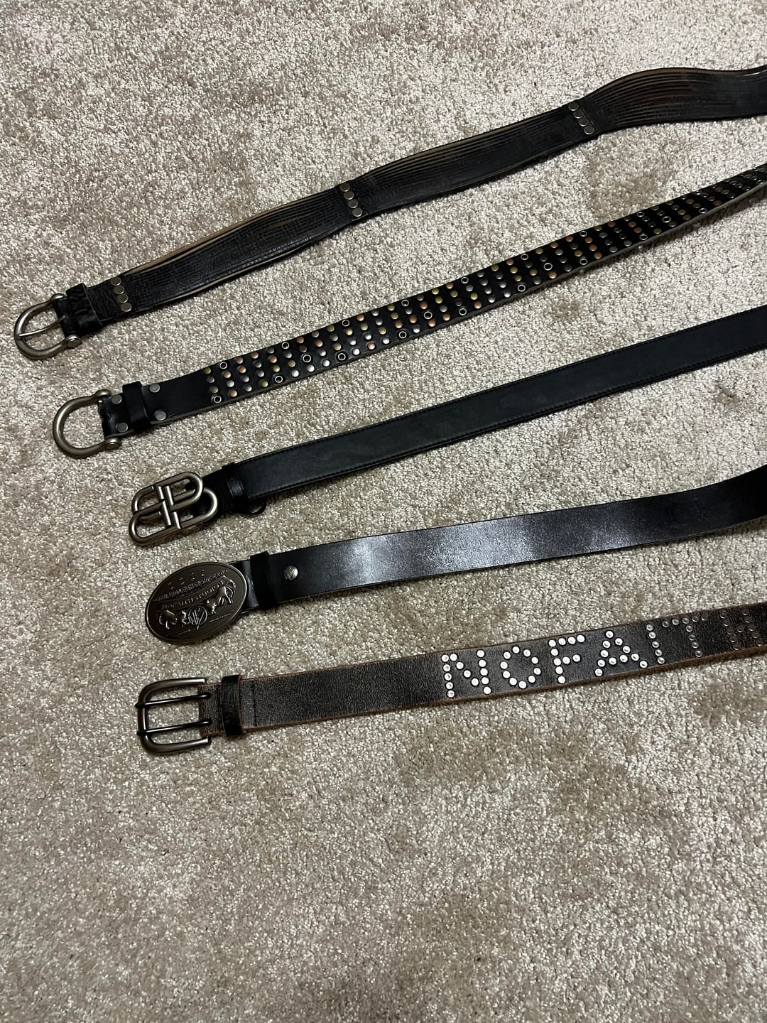 Five belts with different buckles and finishes