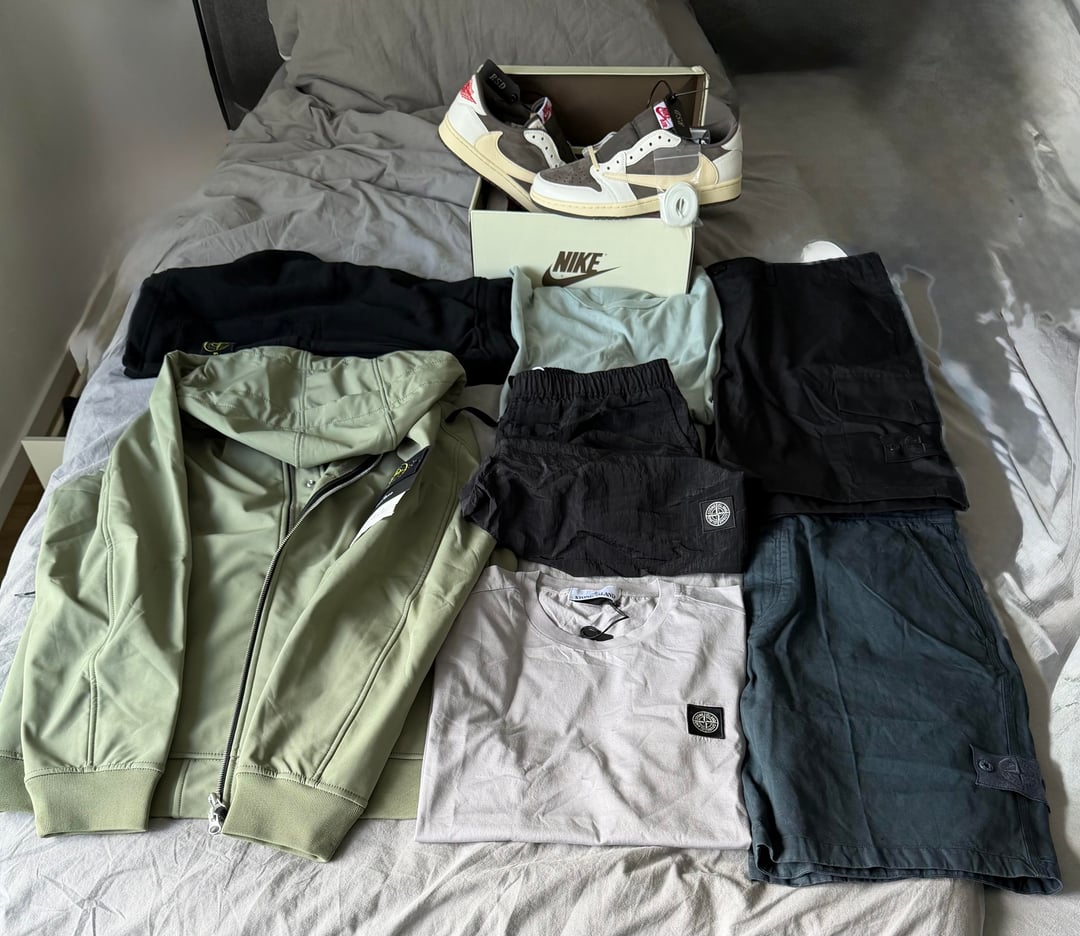 Sage jacket, T-shirts, shorts and trainers laid out together