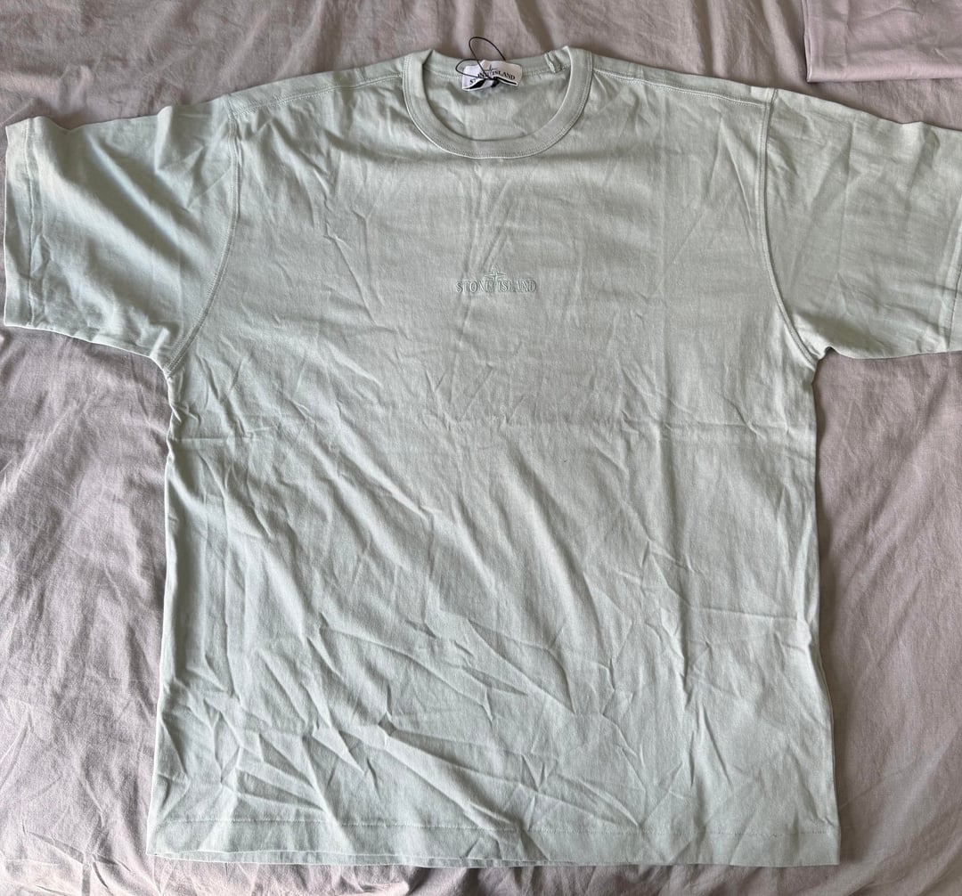 Light-blue embroidered T-shirt laid flat