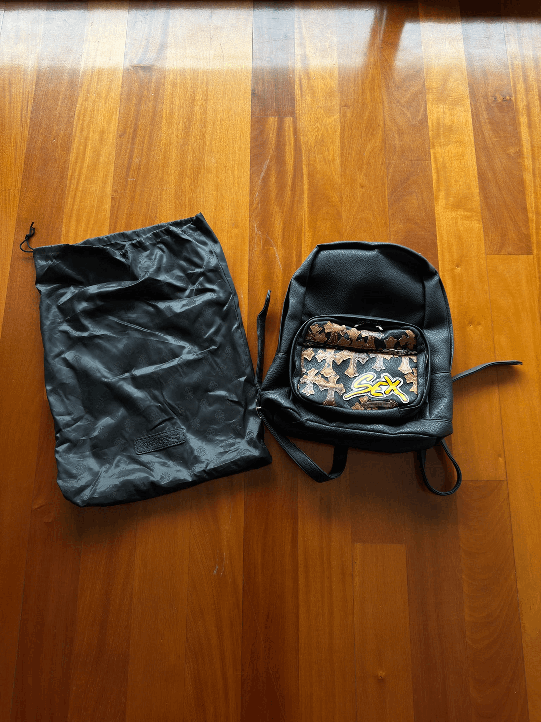 Black backpack with contrasting cross patches, front