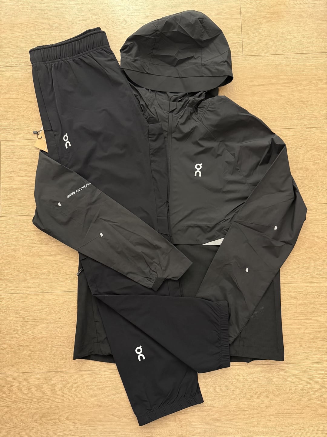 Black athletic tracksuit laid flat