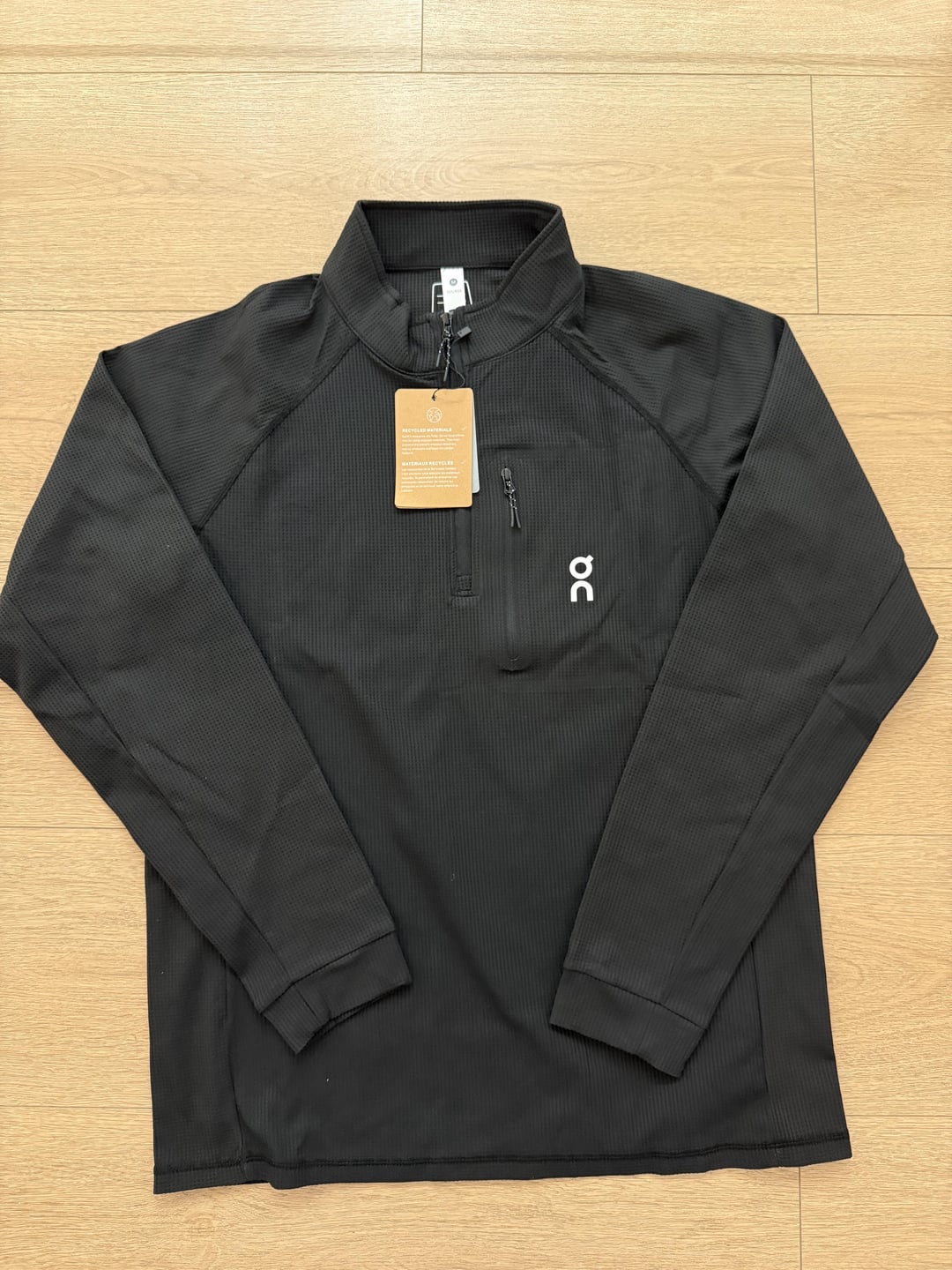 Black quarter-zip long-sleeve top, front