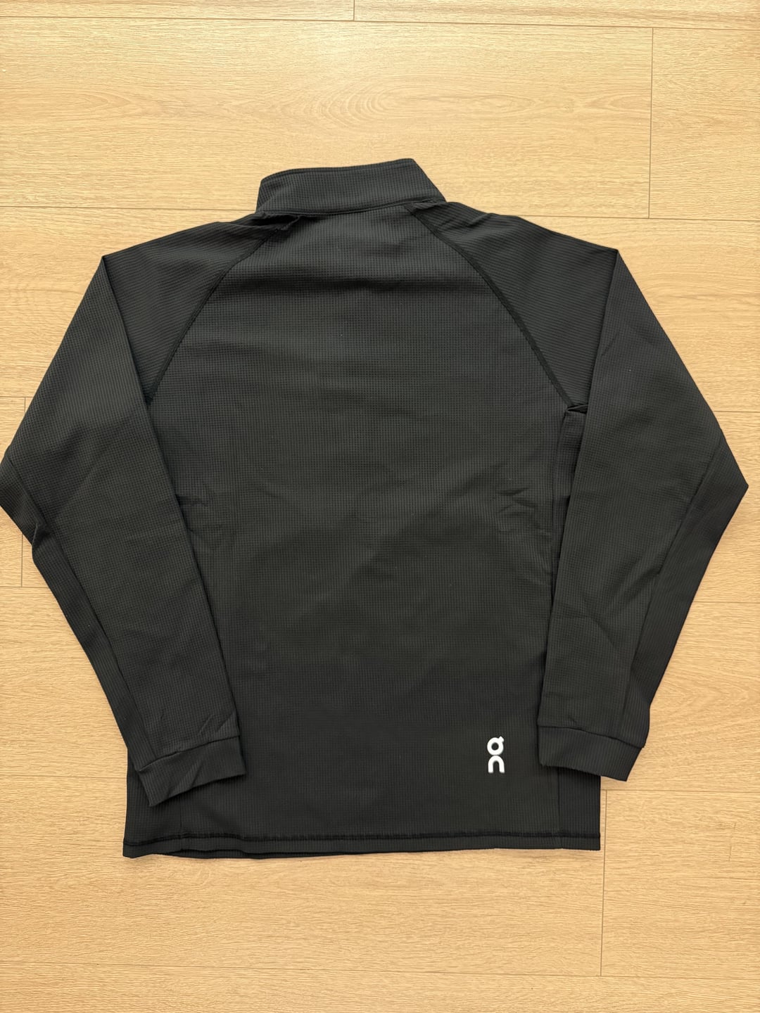 Black quarter-zip long-sleeve top, back